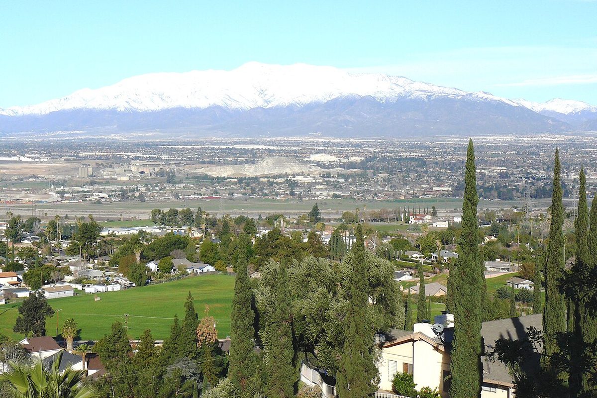 View from Grand Terrace, California, over homes and the valley toward snow-capped mountains